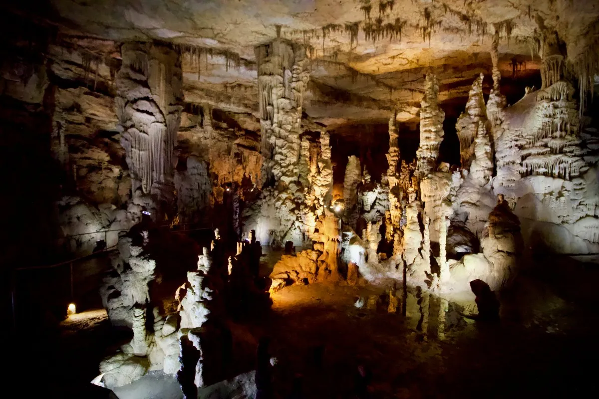 Massive illuminated stalagmites and cave formations inside Cathedral Caverns, Alabama