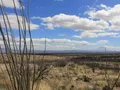 Scenic view at Kartchner Caverns, Arizona, showing dramatic limestone cave formations lit in warm hues of orange and amber