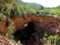 Scenic view of the massive natural travertine arch spanning a lush green canyon at Tonto Natural Bridge, Arizona