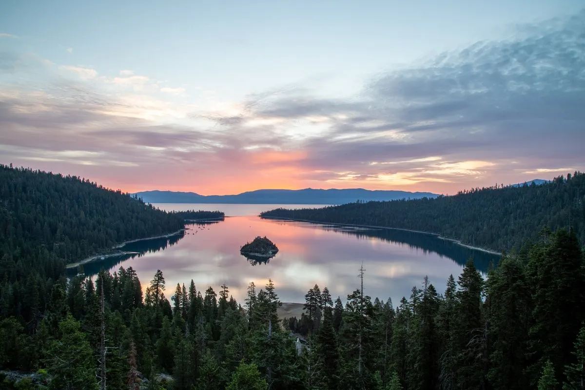 Aerial view of Emerald Bay at Lake Tahoe, California, with glacier-carved turquoise water and forested Sierra Nevada slopes