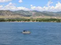 Scenic view of Chatfield Reservoir with open water, shoreline vegetation, and the Rocky Mountain foothills in the background
