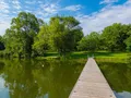 Calm waters of Lake Macbride reflecting surrounding trees and shoreline, Lake Macbride State Park, Iowa