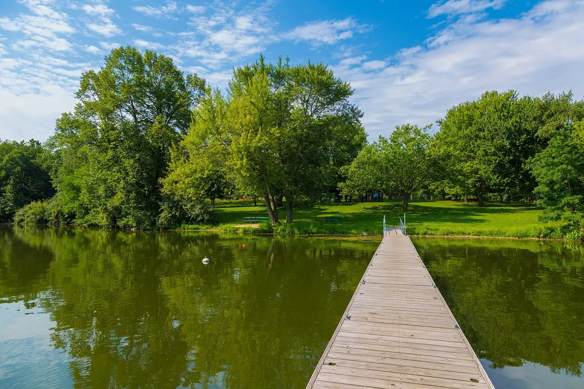 Calm waters of Lake Macbride reflecting surrounding trees and shoreline, Lake Macbride State Park, Iowa