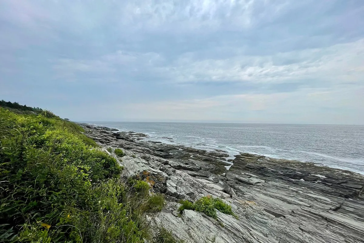 Rocky Atlantic shoreline with crashing waves at Two Lights State Park, Cape Elizabeth, Maine