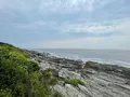 Rocky Atlantic shoreline with crashing waves at Two Lights State Park, Cape Elizabeth, Maine