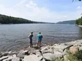 Scenic view of Deep Creek Lake surrounded by forested hills, Maryland