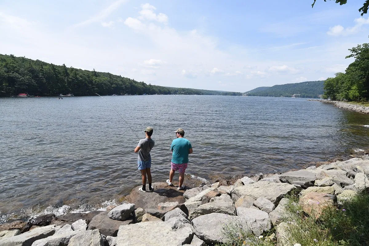 Scenic view of Deep Creek Lake surrounded by forested hills, Maryland