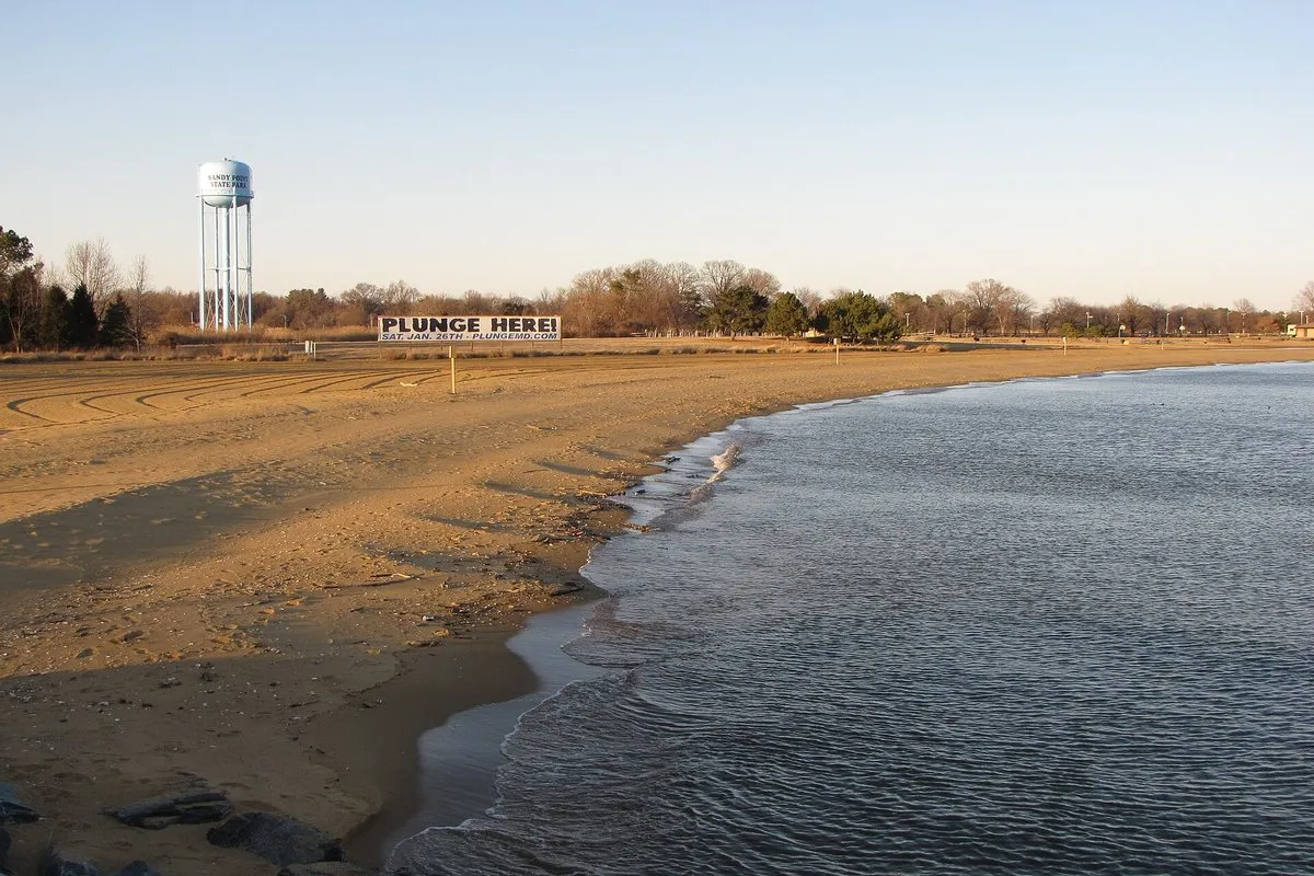Scenic beachfront view at Sandy Point State Park with the Chesapeake Bay Bridge visible in the background, Maryland