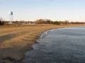 Scenic beachfront view at Sandy Point State Park with the Chesapeake Bay Bridge visible in the background, Maryland