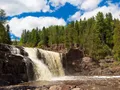 Cascading waterfalls rushing over volcanic rock at Gooseberry Falls, Minnesota
