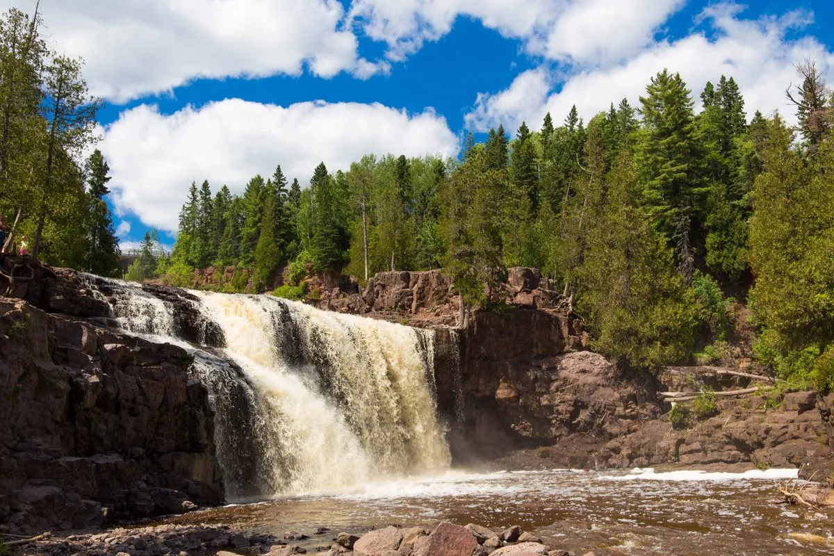 Cascading waterfalls rushing over volcanic rock at Gooseberry Falls, Minnesota