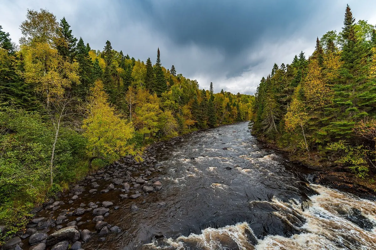 Rushing waterfall and rocky gorge along the Brule River at Judge C.R. Magney State Park, Minnesota