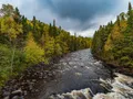 Rushing waterfall and rocky gorge along the Brule River at Judge C.R. Magney State Park, Minnesota