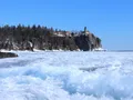 The historic Split Rock Lighthouse perched on a rocky cliff above the blue waters of Lake Superior, Minnesota