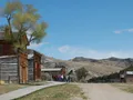 Historic wooden buildings of the Bannack ghost town set against the Montana hills and open sky