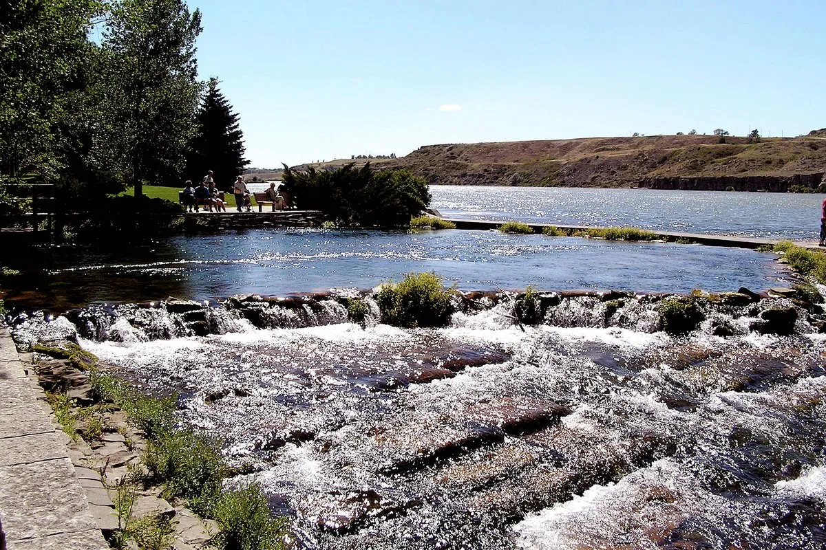 Crystal-clear spring waters flowing from Giant Springs into the Missouri River at Giant Springs State Park, Montana