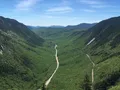 Scenic view of Crawford Notch valley with forested mountain slopes and rocky terrain, New Hampshire