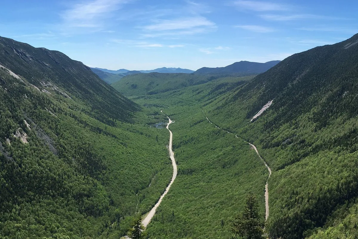 Scenic view of Crawford Notch valley with forested mountain slopes and rocky terrain, New Hampshire