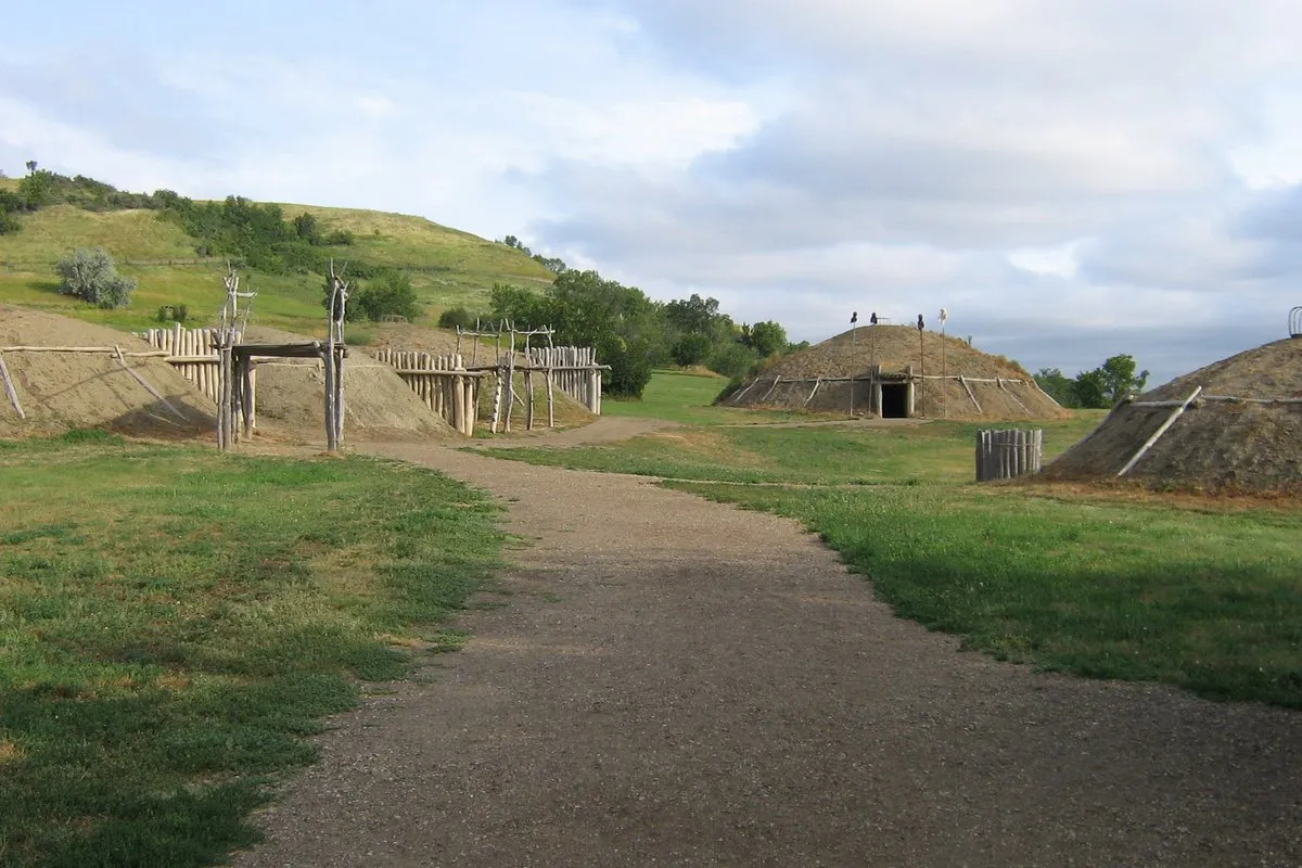 Reconstructed earthlodge structures and open prairie landscape at Fort Abraham Lincoln State Park, North Dakota