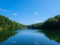 Scenic view of a lush green sandstone gorge with a waterfall at Hocking Hills, Ohio