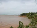 Scenic view of Lake Thunderbird, Oklahoma, with calm water reflecting a blue sky and tree-lined shores