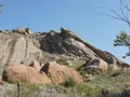 Scenic view at Quartz Mountain, Oklahoma, with rugged granite outcrops rising above the blue waters of Lake Altus-Lugert under a wide open sky