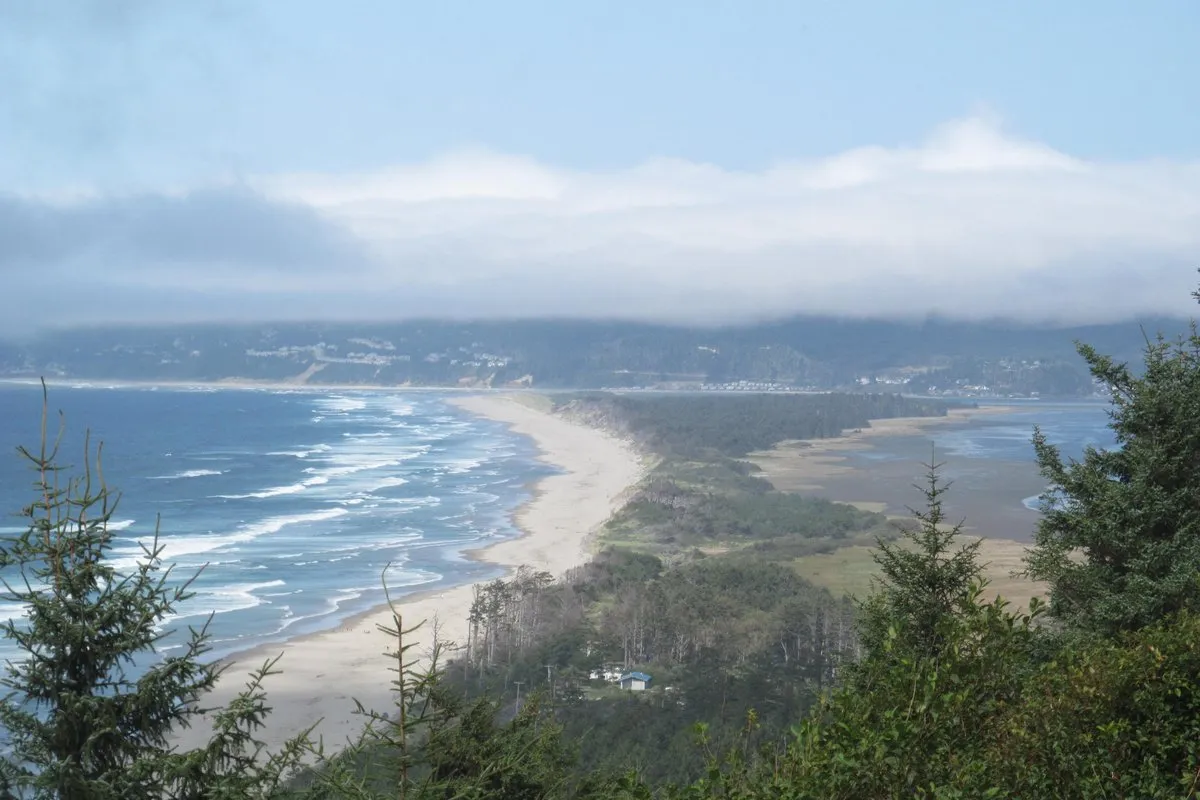Scenic view of the forested Cape Lookout headland jutting into the Pacific Ocean, Oregon