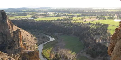 Towering volcanic rock spires reflected in the Crooked River at Smith Rock State Park, Oregon