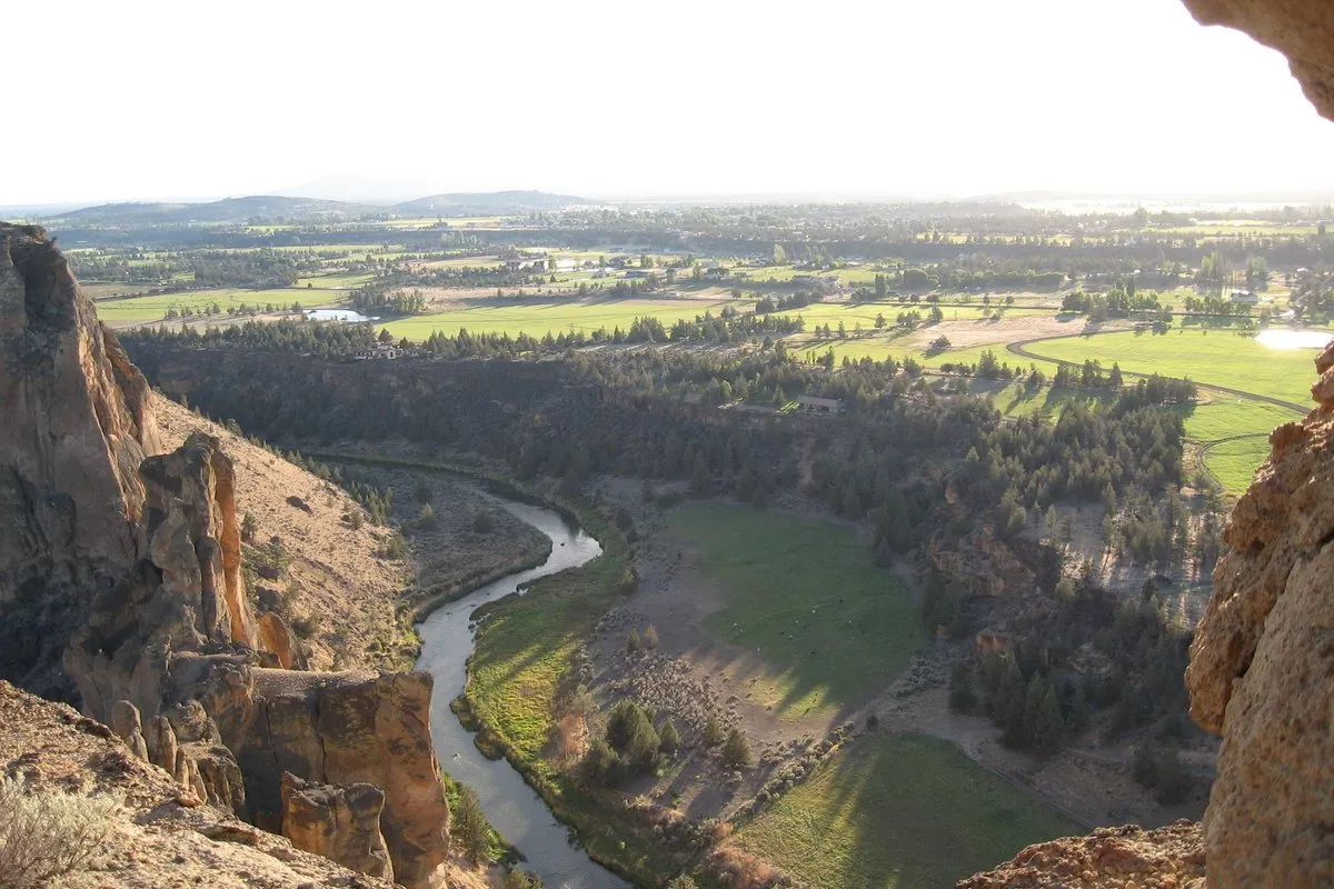 Towering volcanic rock spires reflected in the Crooked River at Smith Rock State Park, Oregon