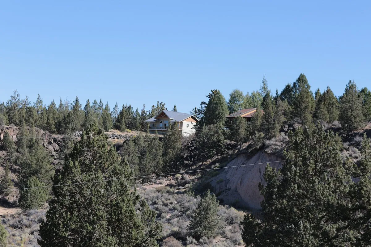 Scenic view at Tumalo State Park, Oregon, with the Deschutes River flowing through a high desert landscape of ponderosa pines