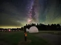Night sky filled with stars and the Milky Way above the dark hilltop meadow at Cherry Springs State Park, Pennsylvania