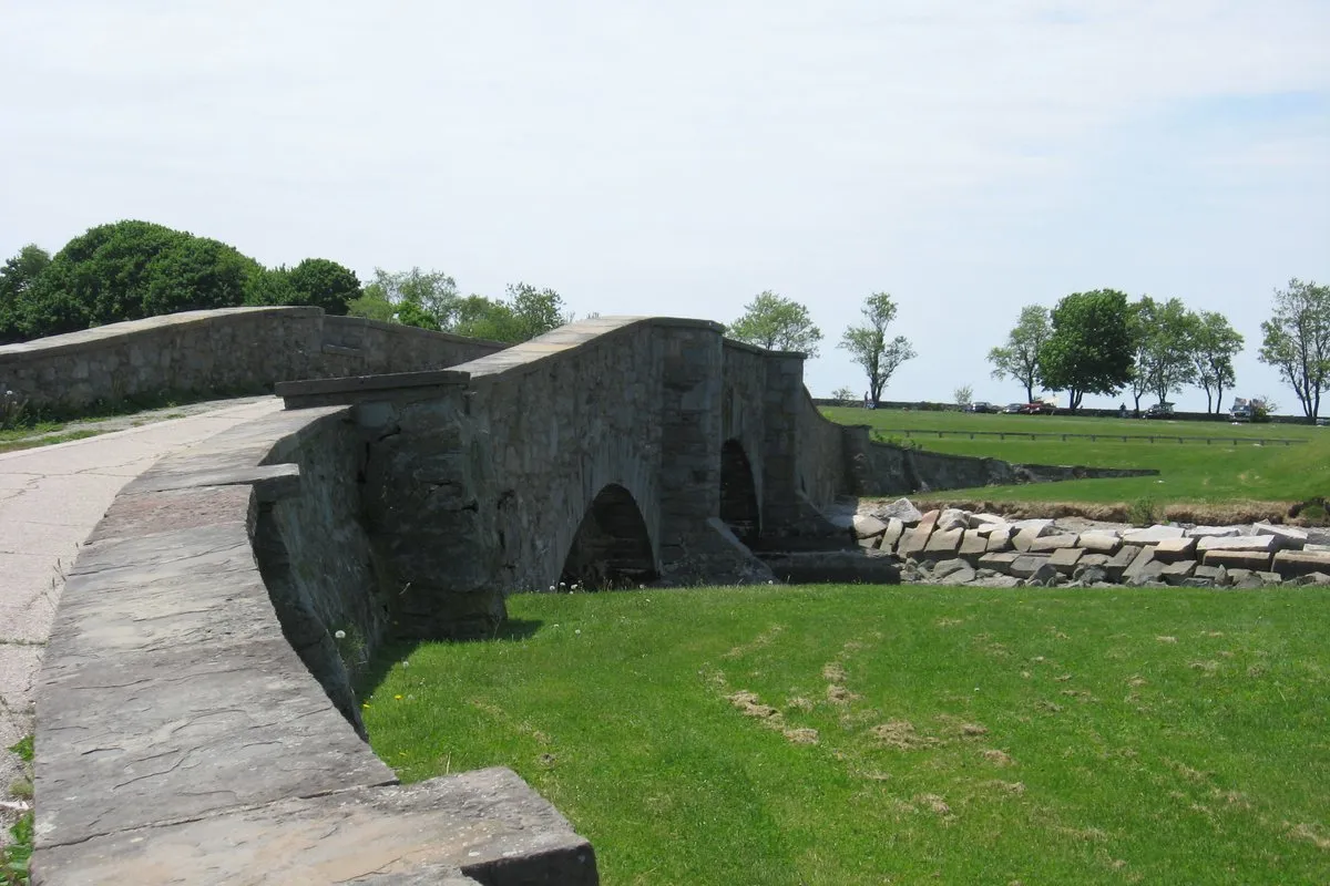 Scenic coastal view of manicured lawns and Narragansett Bay shoreline at Colt State Park, Rhode Island