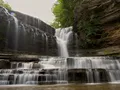 Scenic waterfall cascading into a rocky gorge pool at Cummins Falls State Park, Tennessee