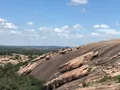 Scenic view of the massive pink granite dome at Enchanted Rock rising above the Texas Hill Country landscape