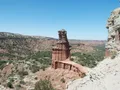 Scenic view at Palo Duro Canyon, Texas, showing dramatic red and orange layered rock formations under a wide open sky