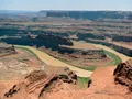 Panoramic view of the Colorado River winding through red rock canyons far below the mesa at Dead Horse Point, Utah