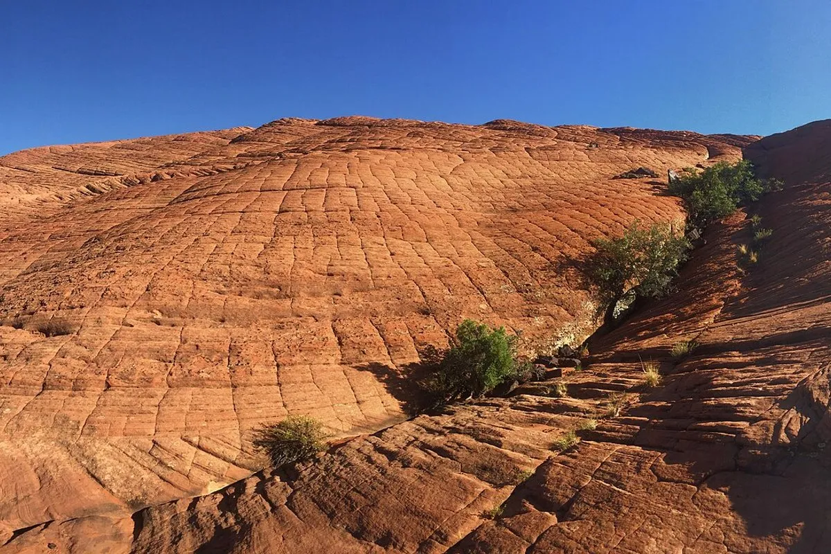 Sweeping view of red sandstone cliffs and lava rock formations at Snow Canyon State Park, Utah