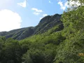 Scenic view of the rocky mountain pass at Smugglers' Notch, Vermont, with forested slopes and dramatic boulder-strewn terrain