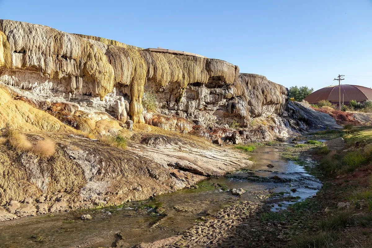 Colorful mineral terraces and steaming hot spring pools at Hot Springs State Park, Wyoming